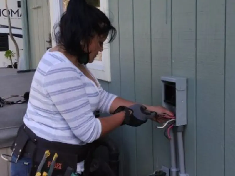 Licensed electrician wiring an exterior subpanel in Mont Belvieu